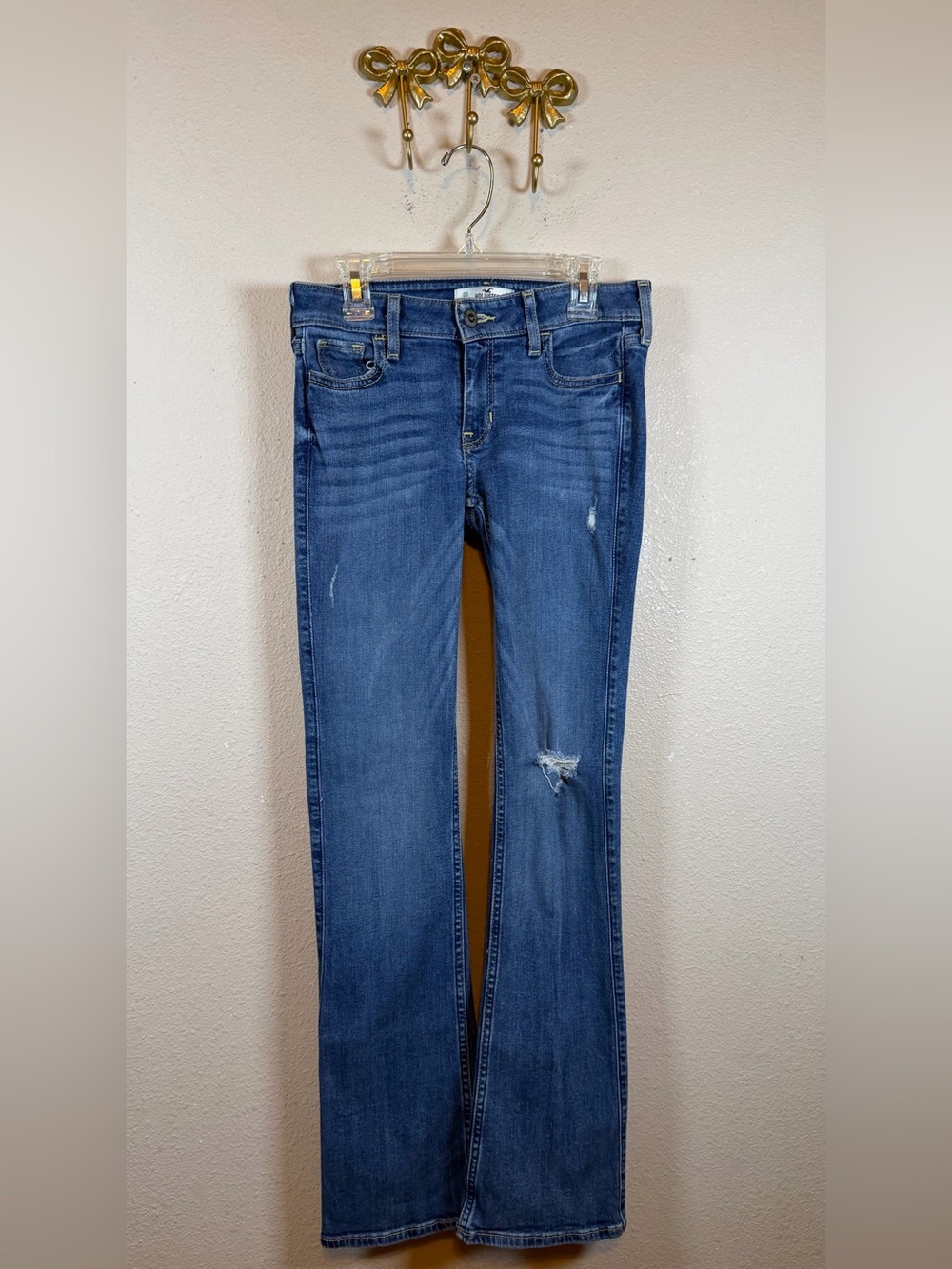 Hollister Women's Blue Flare Jeans with Knee Distress. Size OS